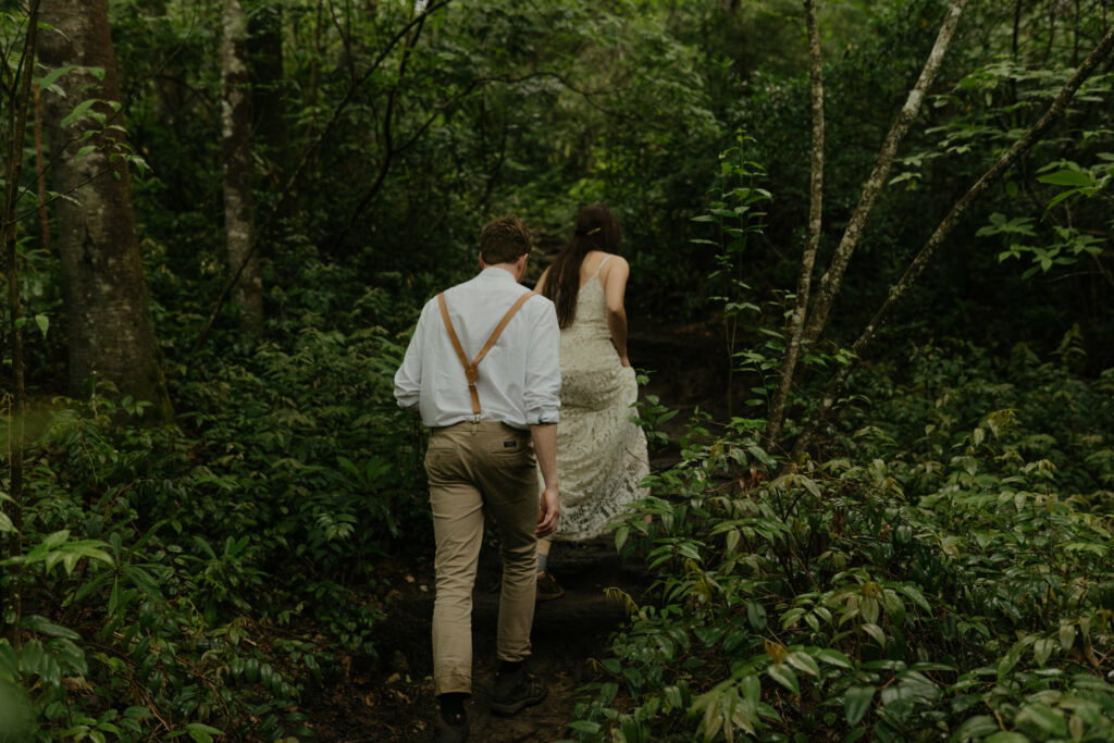 A couple is hiking through the forest in North Carolina during their elopement day.