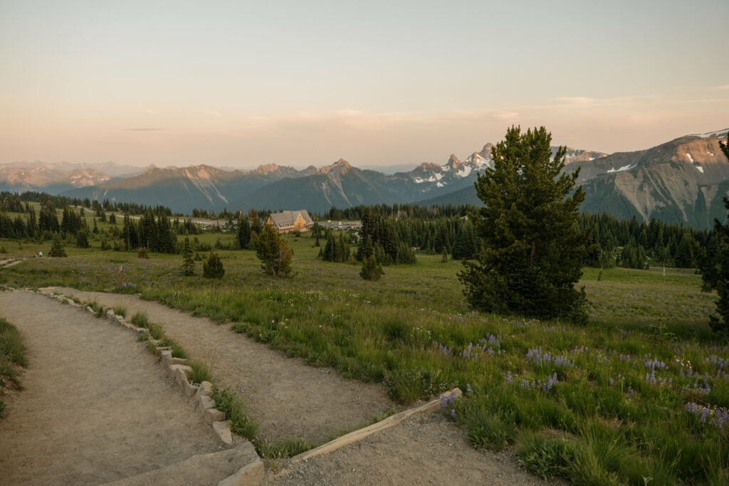 A view of the Sunrise area of Mt Rainier National park with a trail and the sunrise visitor day lodge and mountain in the background. Best Location for a Mount Rainier Elopement.