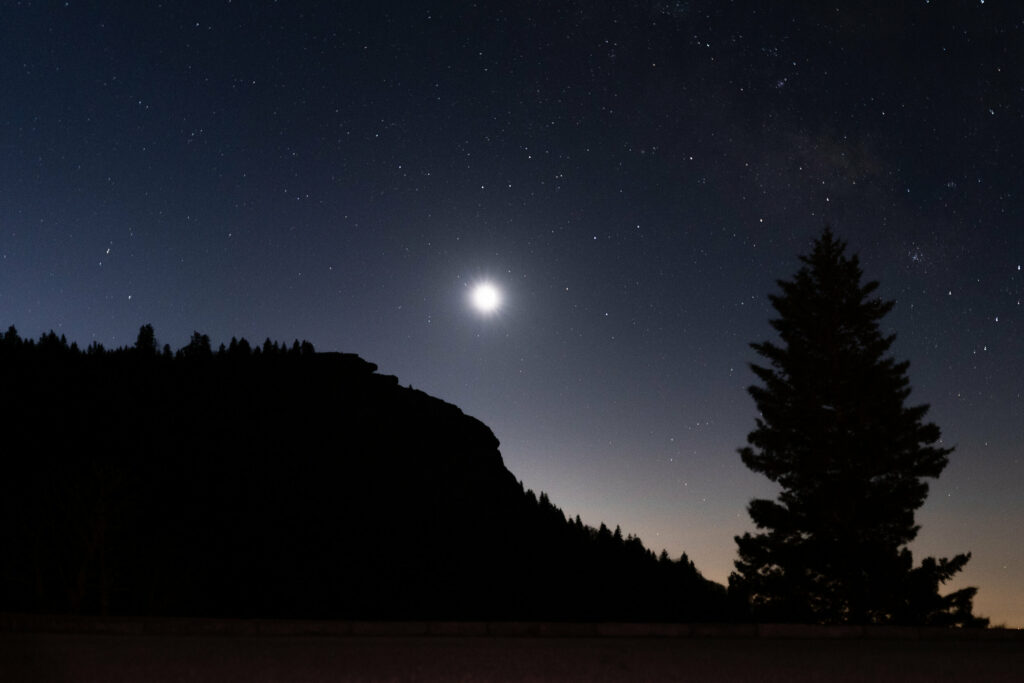 Long exposure image of the moon and stars just before sunrise.