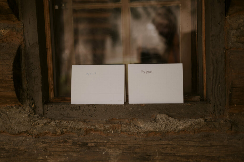 Handwritten love notes sit on a windowsill.