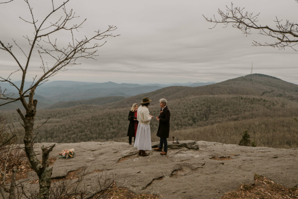 A couple exchanges vows during a mountain winter elopement in western North Carolina.