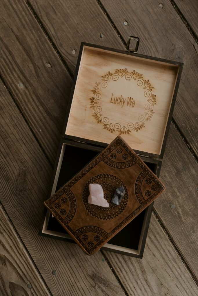 Elopement vows are written in a leather bound book sitting in a custom box.
