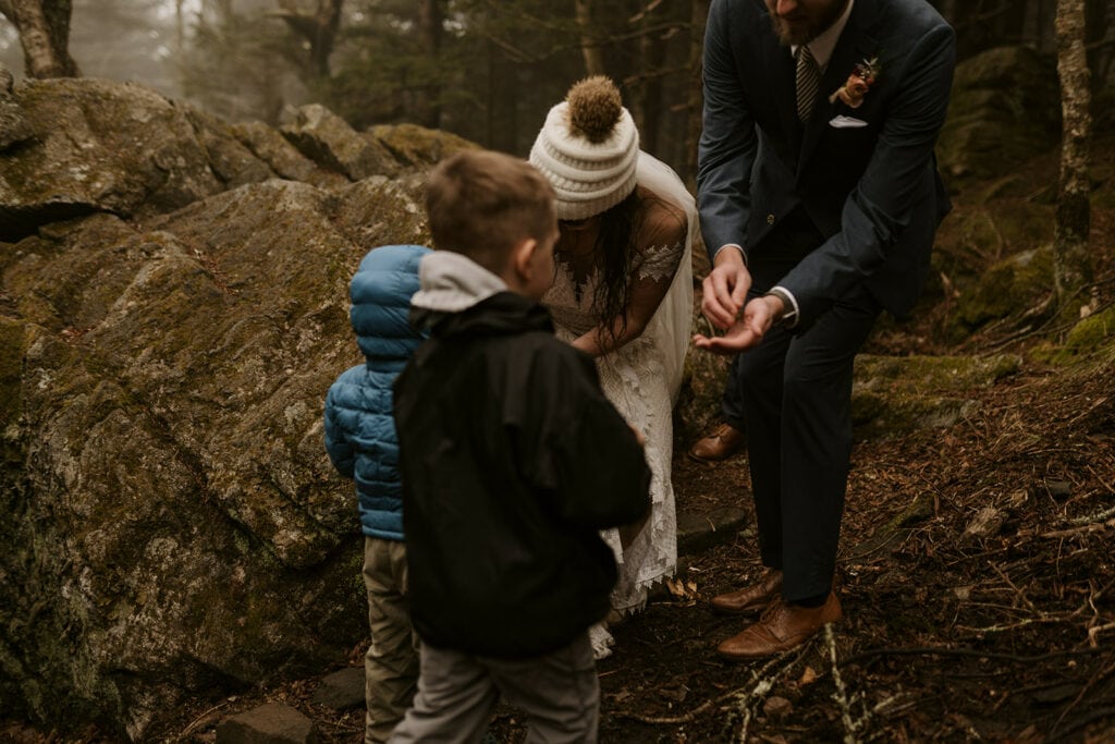 Little children delivering rings to the bride and groom during their elopement ceremony