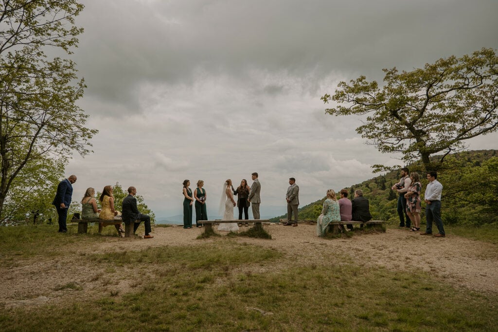 A group of people are having an elopement ceremony at an overlook on the Blue Ridge Parkway; one of the best places to elope in NC.