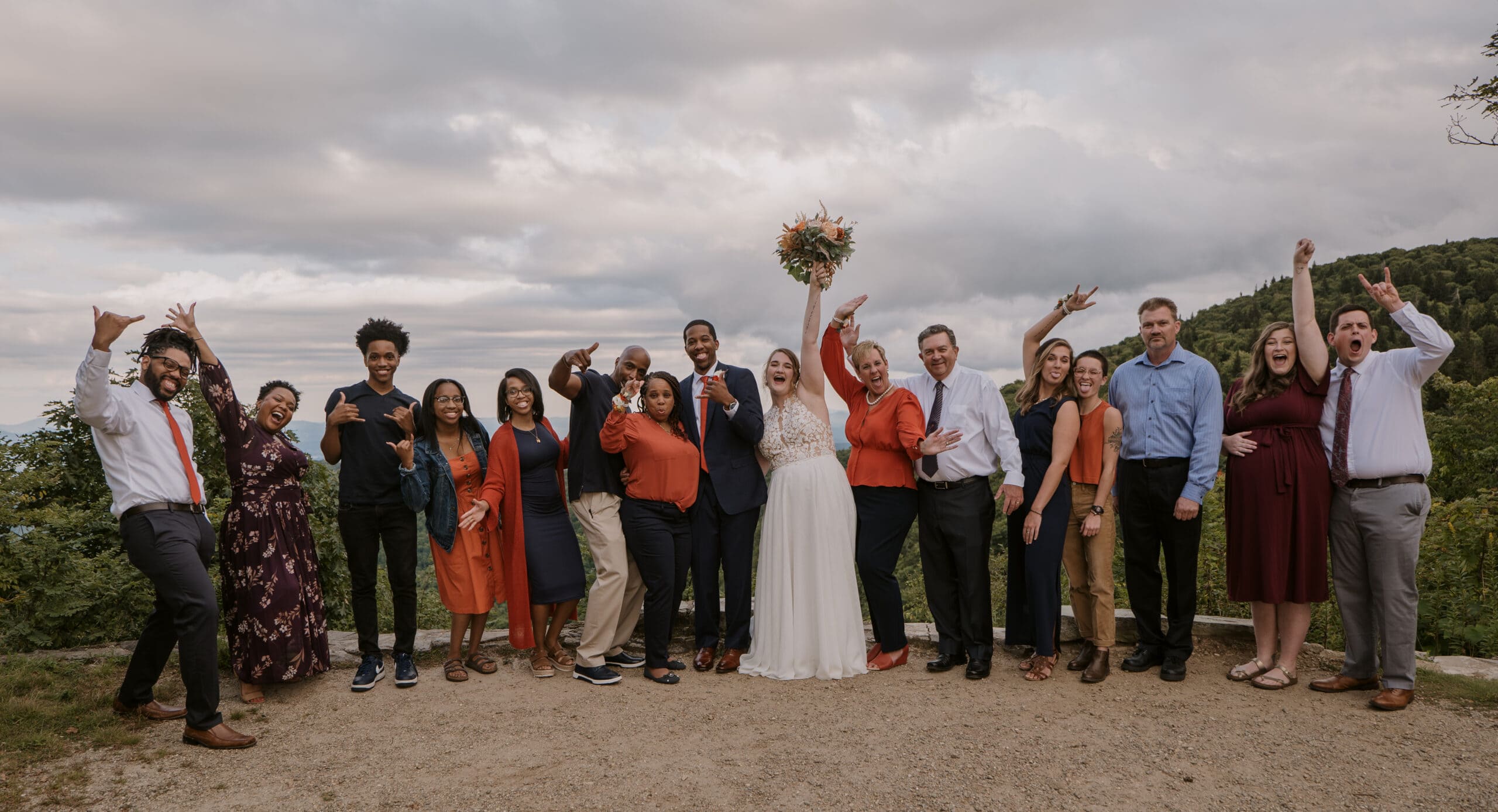 Eloped couples standing with their family whiles celebrating their marriage