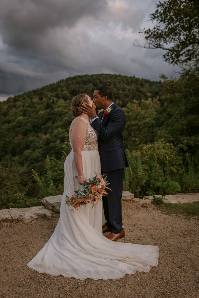Bride and Groom Kissing in the Mountains after their Elopement