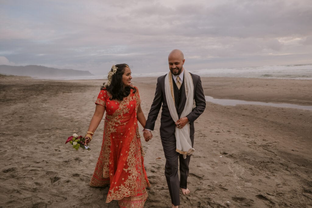 Bride and Groom Walking on Beach during Elopement