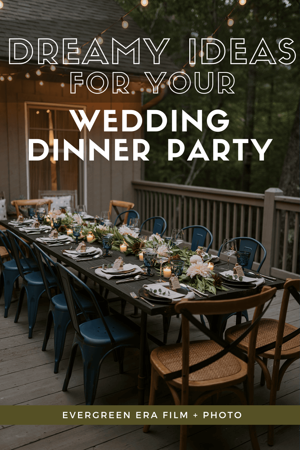 A wedding dinner party set up with string lights on a porch in a forest. There are beautiful colorful flowers and candles with a dark table, blue chairs, and wooden chairs.